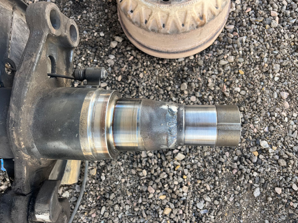 Heavy-duty truck undergoing spindle repair at AZ Axle Medic.